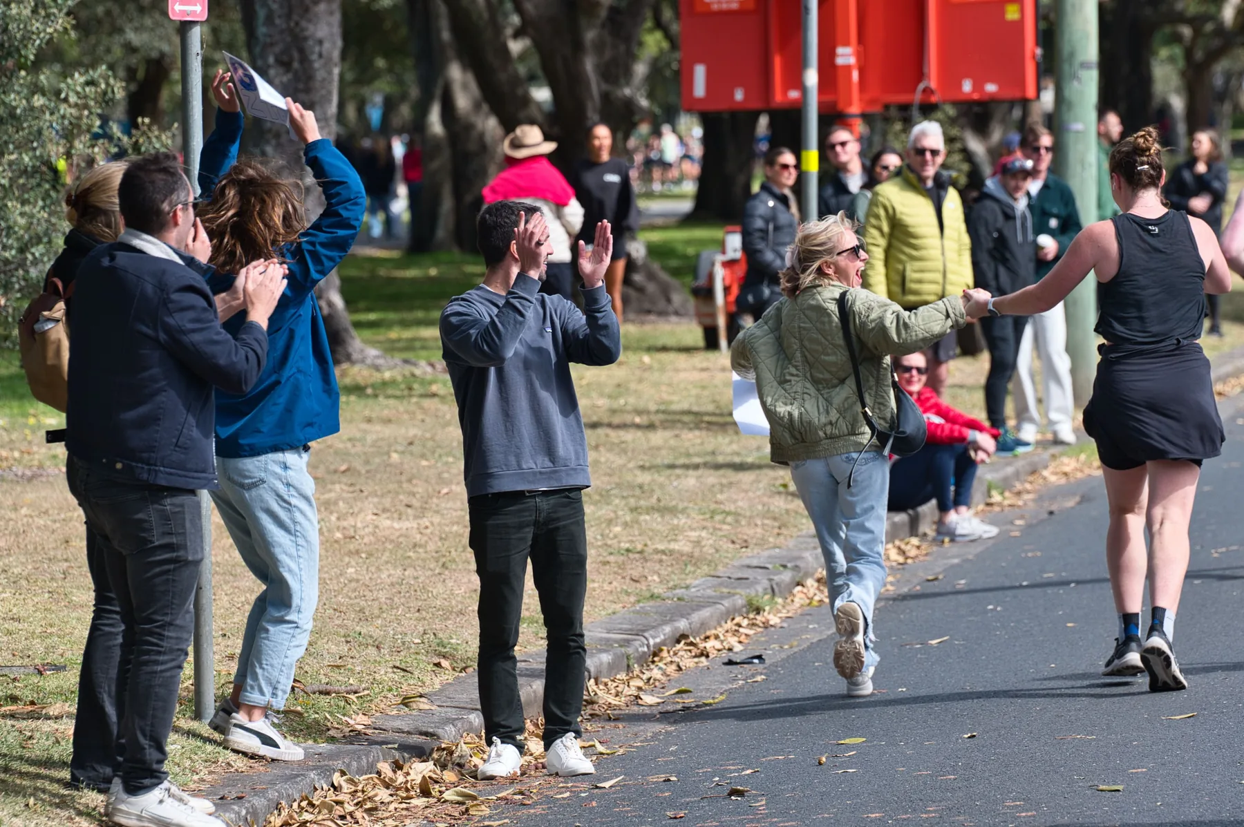 Supporters cheering on a runner